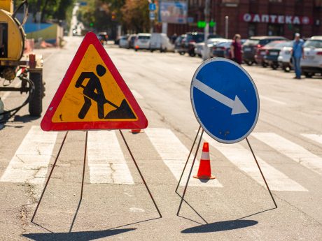 Road repair. Warning signs about repair work of a paving. Attention detour.